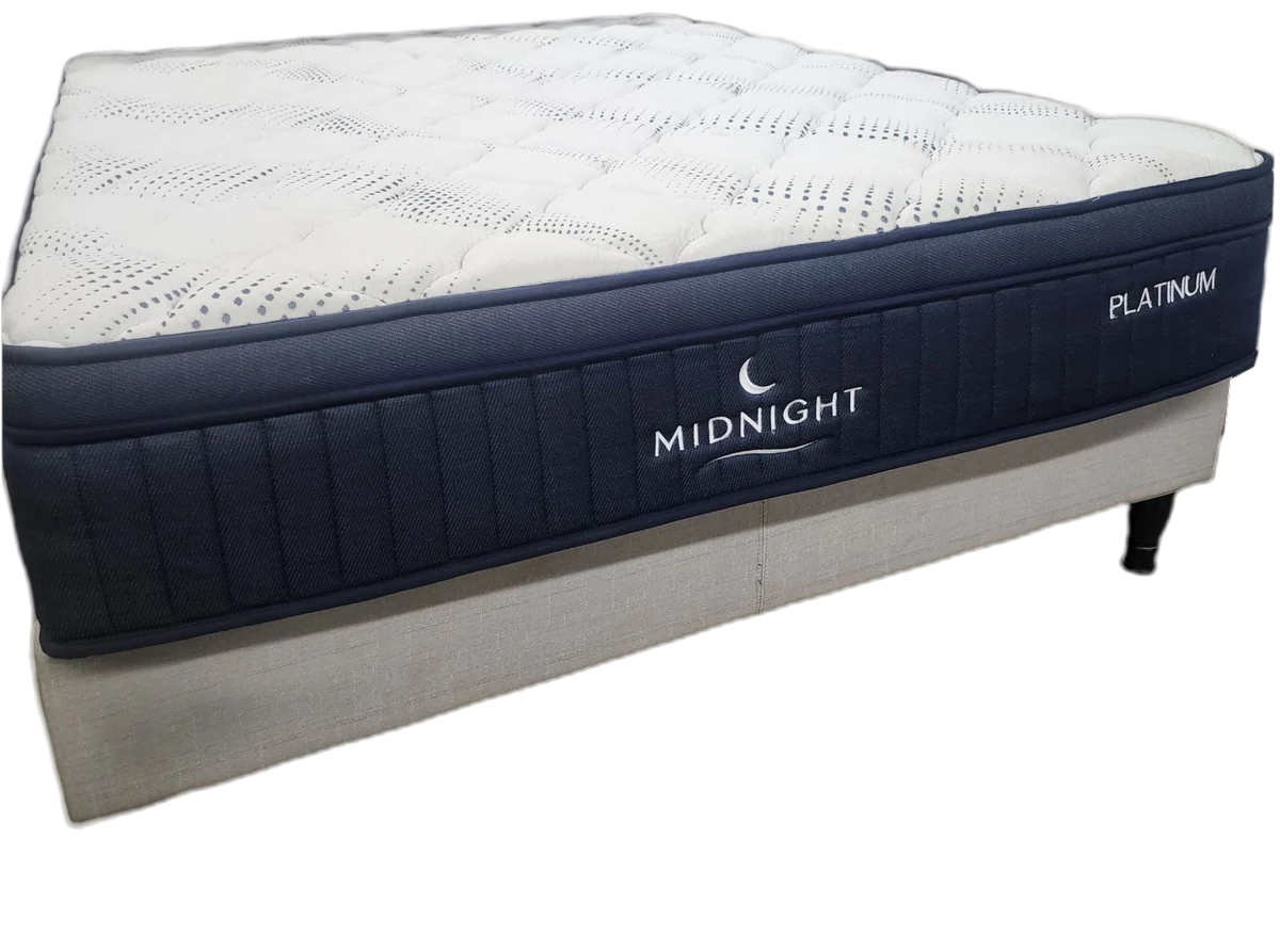 The Midnight Platinum mattress on its base, cut out: a navy border under a quilted top.